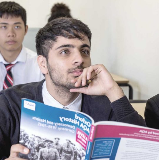 CSFC students sitting in class with textbook