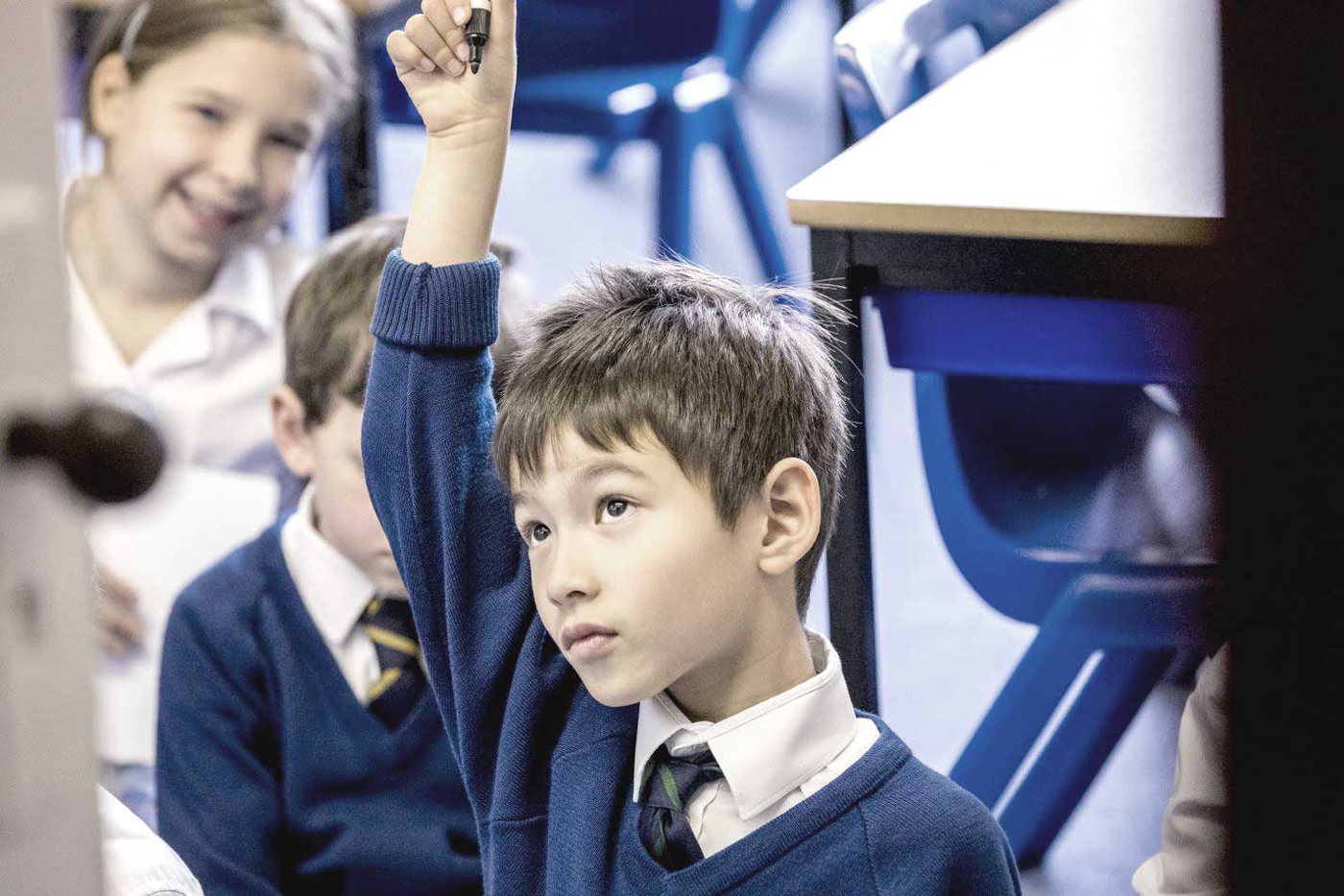boy in class raising his hand