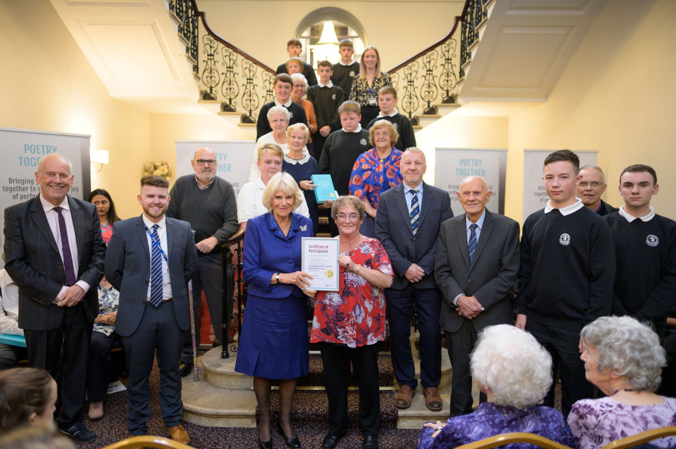 The Duchess of Cornwall awarding a certificate
